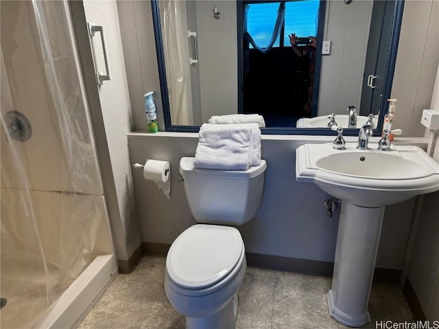 bathroom with toilet, a shower with shower curtain, tile patterned flooring, and sink