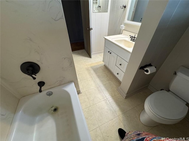 bathroom featuring toilet, vanity, and a tub to relax in