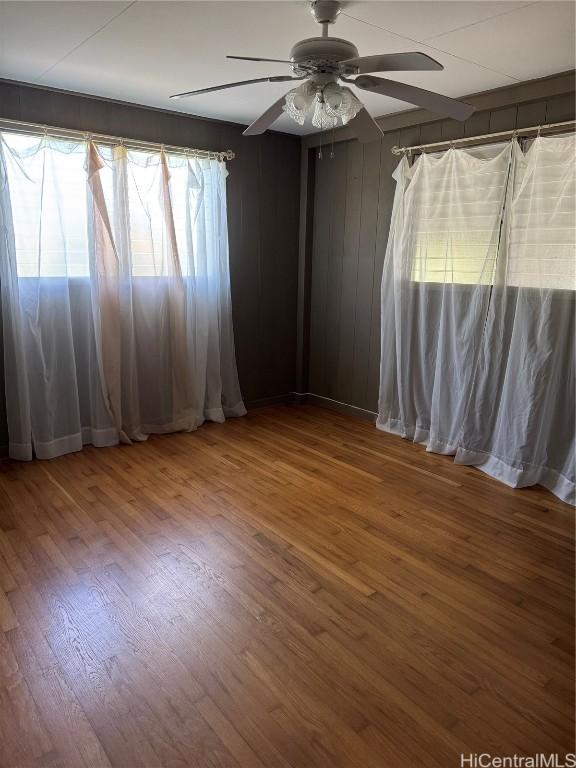 spare room featuring ceiling fan and hardwood / wood-style floors