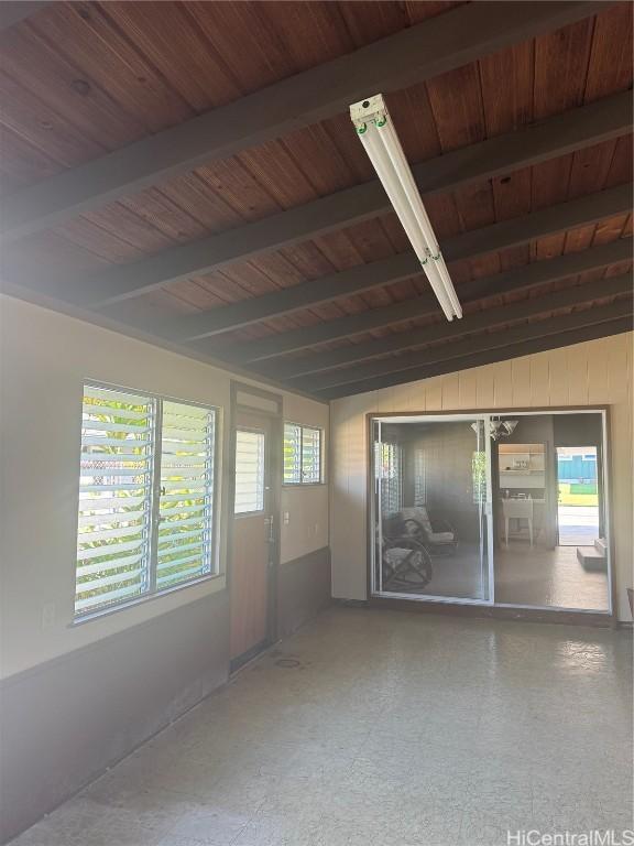 spare room with wooden ceiling and lofted ceiling with beams