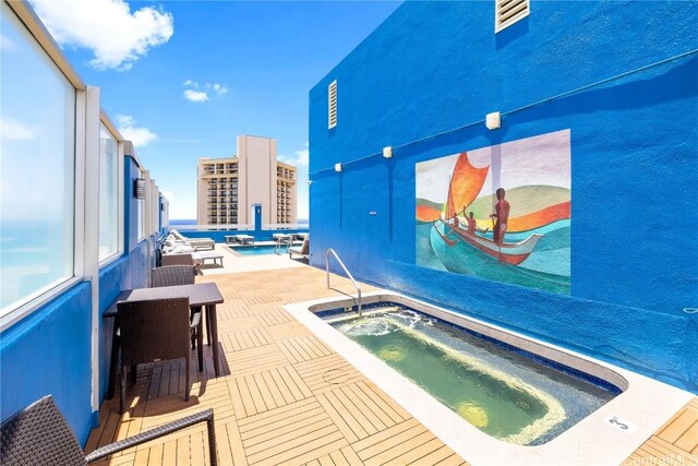 view of swimming pool featuring a patio and a hot tub