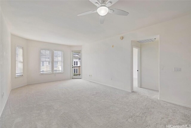 carpeted spare room with ceiling fan