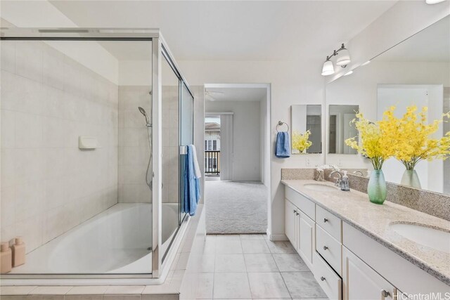 bathroom featuring vanity, tile patterned flooring, and bath / shower combo with glass door