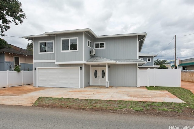 view of front facade featuring a wall mounted air conditioner and a garage