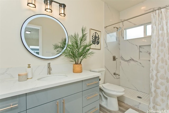 bathroom featuring toilet, vanity, hardwood / wood-style floors, and a shower with shower curtain