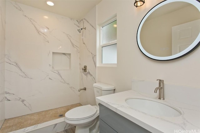 bathroom with toilet, vanity, and walk in shower