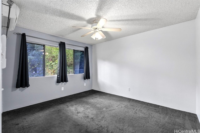 carpeted empty room with ceiling fan and a textured ceiling