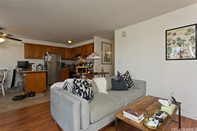 living room with ceiling fan and wood-type flooring