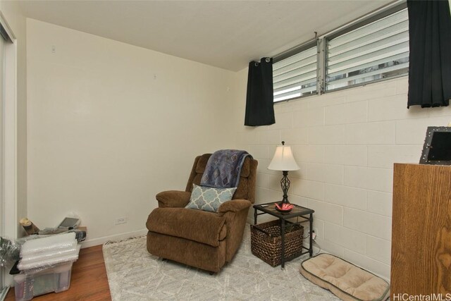 sitting room with hardwood / wood-style flooring