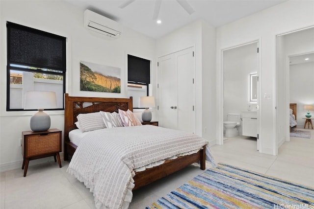 tiled bedroom with ceiling fan, connected bathroom, a closet, and a wall mounted AC