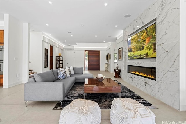 living room featuring a high end fireplace and a wealth of natural light