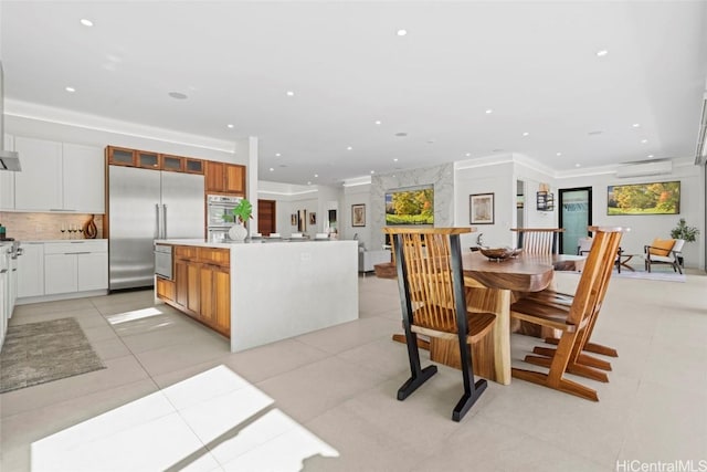 tiled dining room featuring an AC wall unit