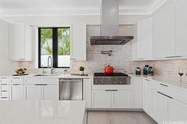 kitchen featuring extractor fan, stainless steel appliances, decorative backsplash, white cabinets, and sink