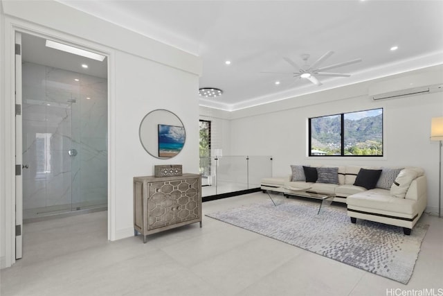 living room with ceiling fan and a wall mounted air conditioner