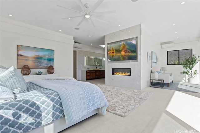 bedroom featuring ceiling fan, a wall unit AC, and a tiled fireplace