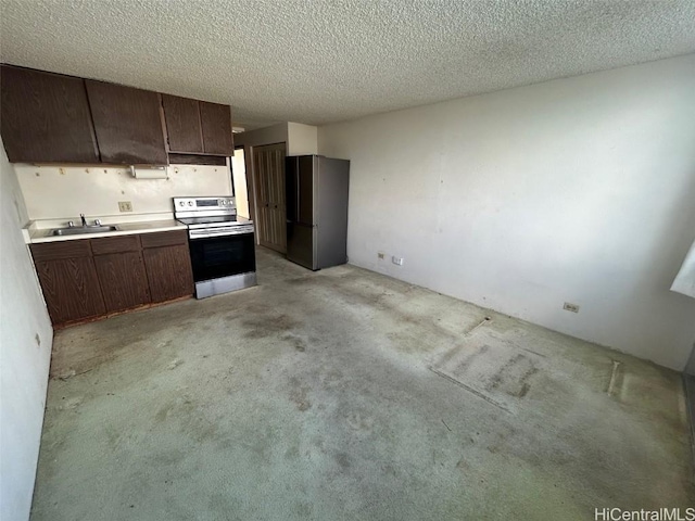 kitchen with sink, dark brown cabinetry, stainless steel appliances, and light carpet