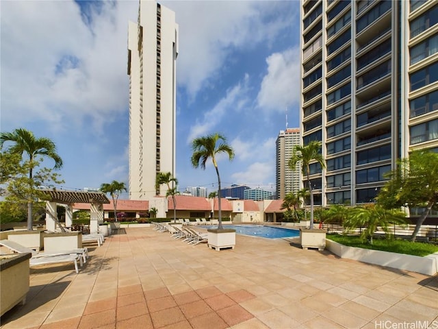 exterior space featuring a community pool and a pergola