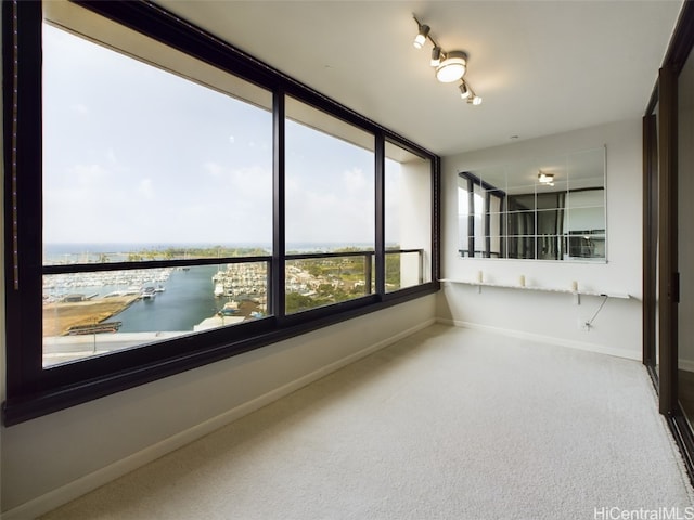 unfurnished sunroom with a water view