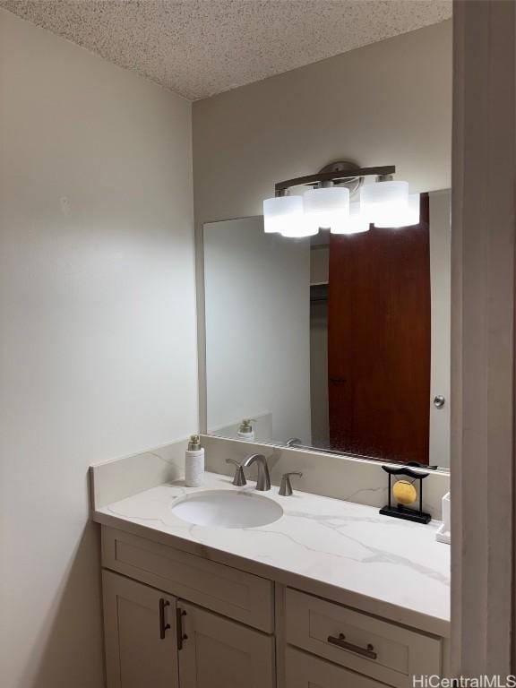 bathroom with vanity and a textured ceiling