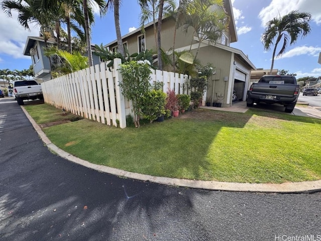 view of home's exterior featuring a lawn and a garage