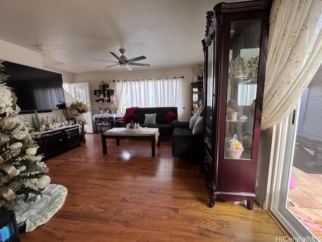 living room featuring hardwood / wood-style flooring and ceiling fan