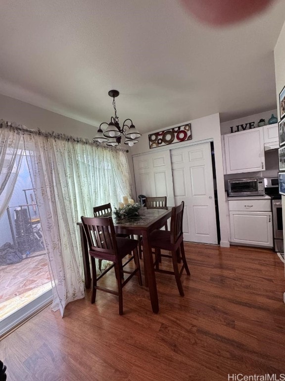 dining space featuring a chandelier and dark hardwood / wood-style flooring