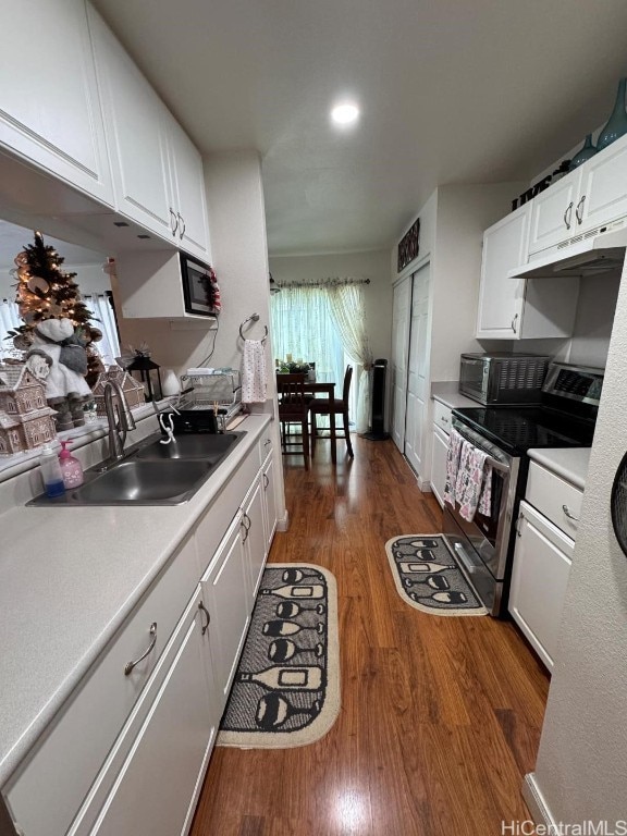 kitchen featuring white cabinetry, dark hardwood / wood-style flooring, stainless steel electric range oven, and sink