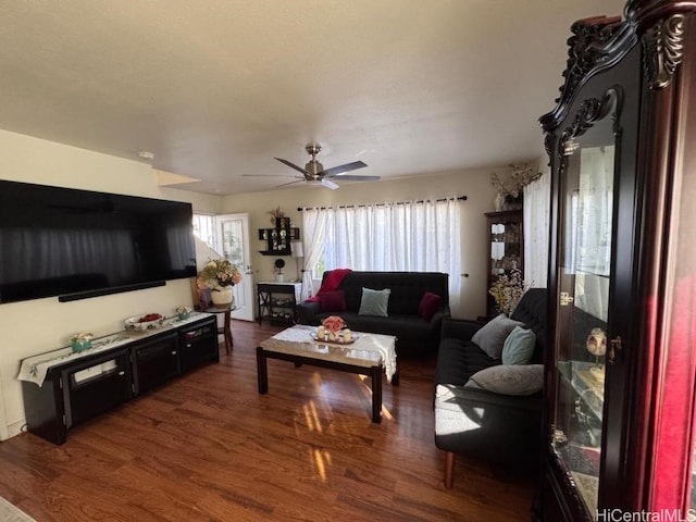 living room featuring dark hardwood / wood-style flooring and ceiling fan