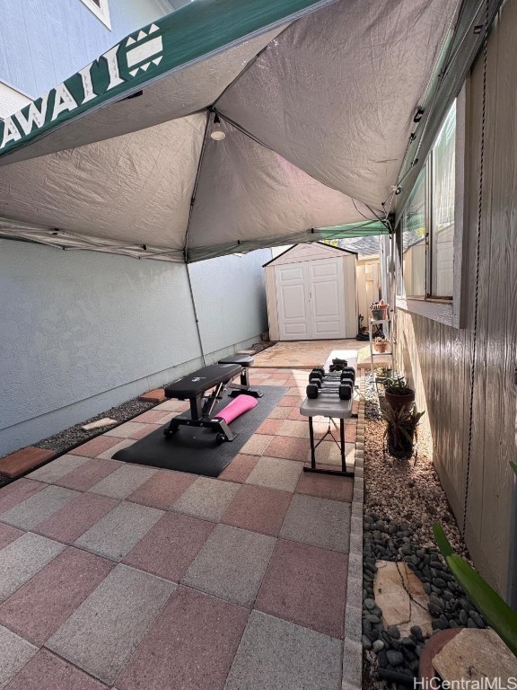 view of patio / terrace featuring a shed