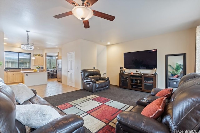 carpeted living room featuring ceiling fan