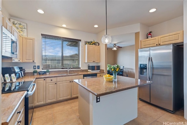 kitchen featuring stainless steel appliances, sink, light tile patterned floors, decorative light fixtures, and a kitchen island