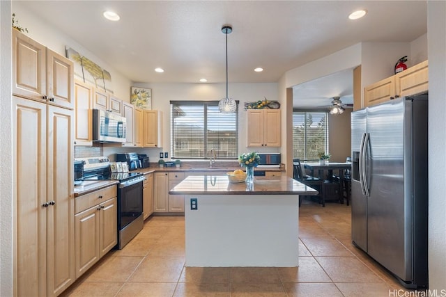 kitchen featuring a center island, sink, stainless steel appliances, decorative light fixtures, and light tile patterned floors