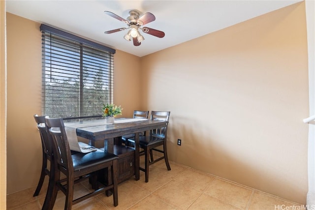 tiled dining area with ceiling fan