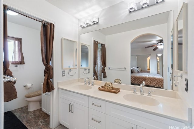 bathroom featuring ceiling fan, toilet, and vanity