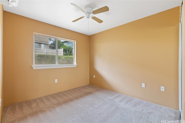 carpeted spare room featuring ceiling fan