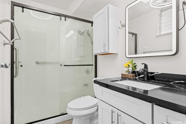 bathroom featuring baseboard heating, a shower with door, vanity, and toilet