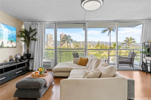 living room with hardwood / wood-style floors and expansive windows