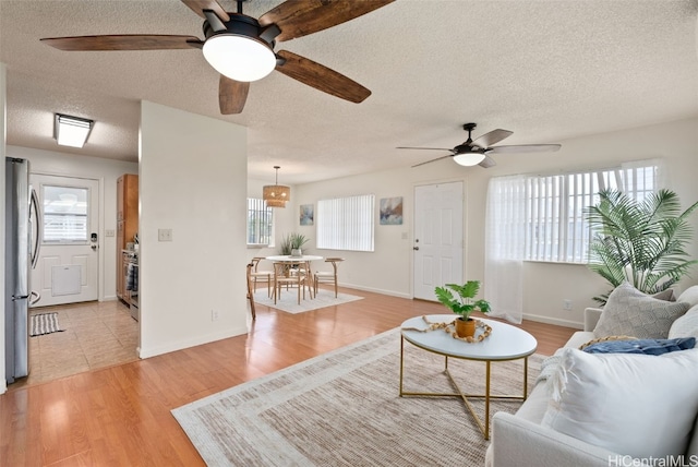 living room with a textured ceiling and light hardwood / wood-style floors