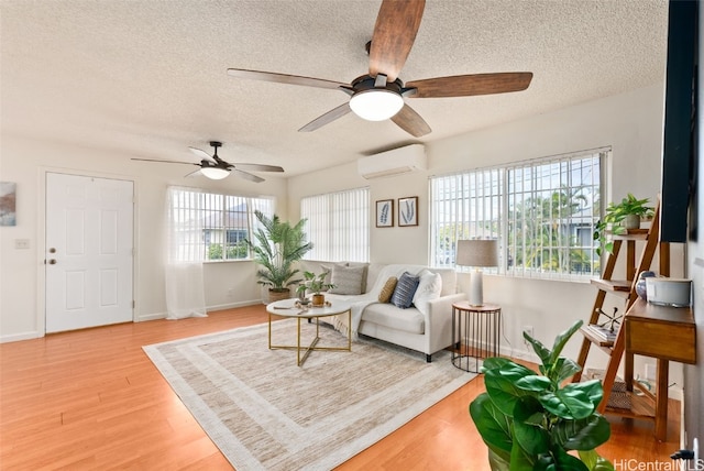 interior space with hardwood / wood-style flooring, a textured ceiling, and a wall unit AC