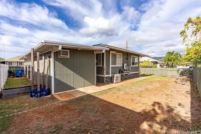 rear view of house featuring ac unit