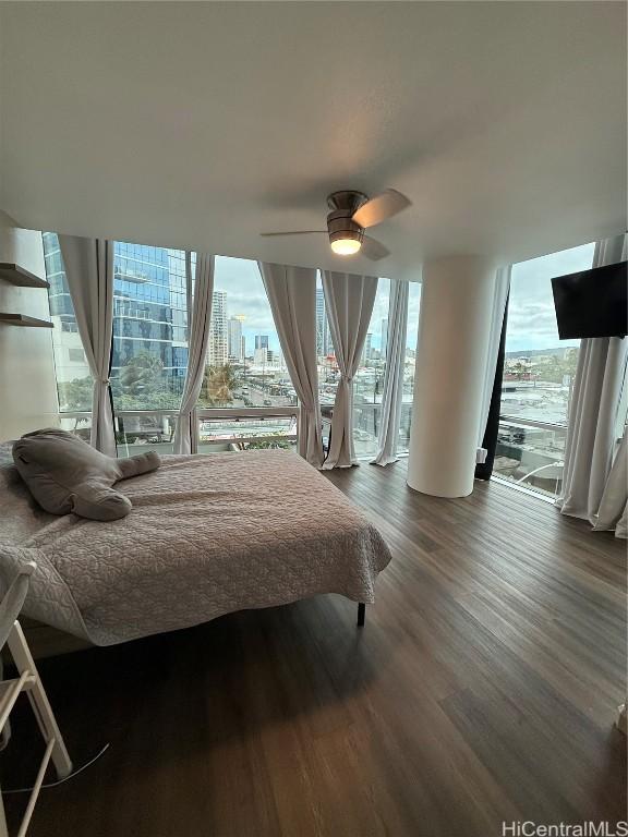 bedroom with dark hardwood / wood-style floors, access to exterior, and ceiling fan