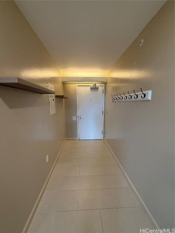 corridor featuring light tile patterned floors