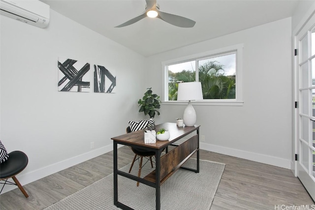 home office featuring ceiling fan, wood-type flooring, and a wall mounted air conditioner