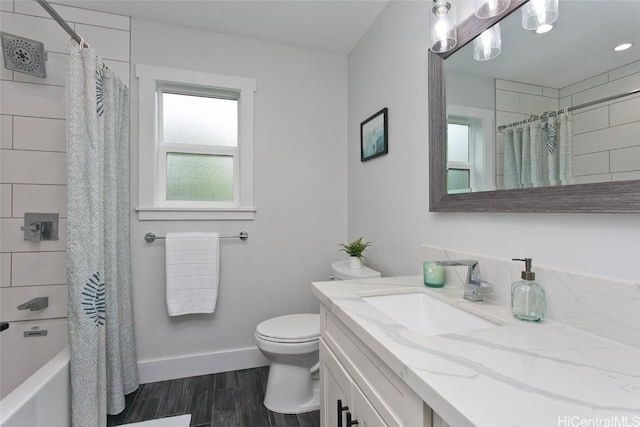 full bathroom featuring toilet, vanity, and shower / bathtub combination with curtain