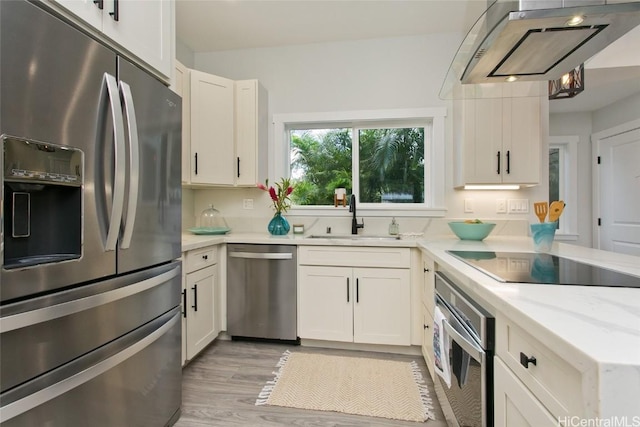 kitchen featuring light hardwood / wood-style floors, sink, white cabinetry, and appliances with stainless steel finishes