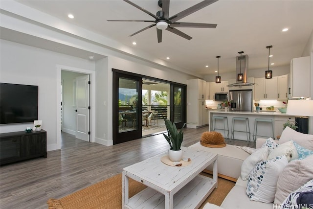 living room featuring light wood-type flooring and ceiling fan