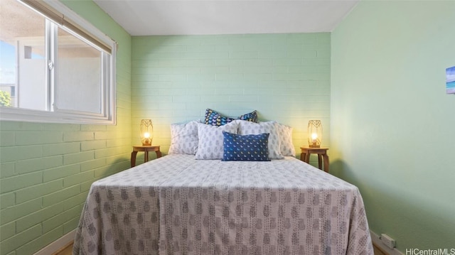 bedroom with brick wall