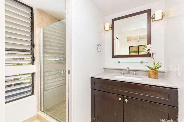 bathroom with a shower with door and vanity