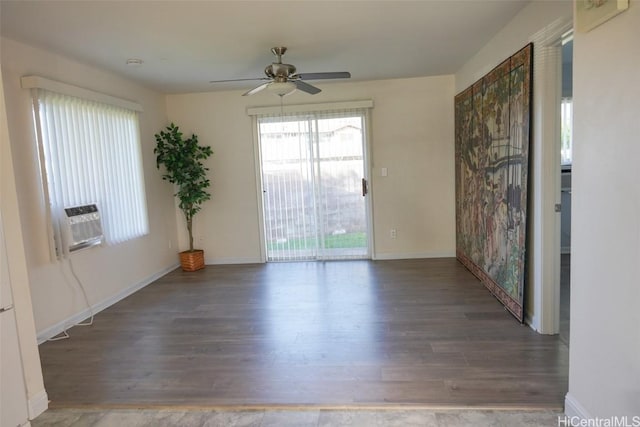 spare room featuring ceiling fan, cooling unit, and dark wood-type flooring