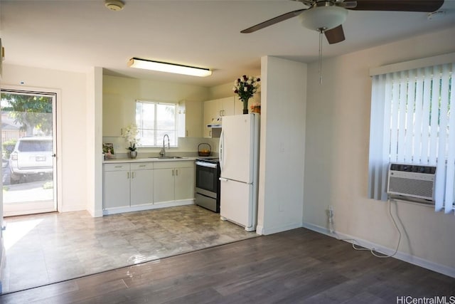 kitchen featuring stainless steel electric stove, white refrigerator, a healthy amount of sunlight, and sink